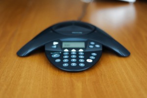 Conference business phone on a wooden meeting room